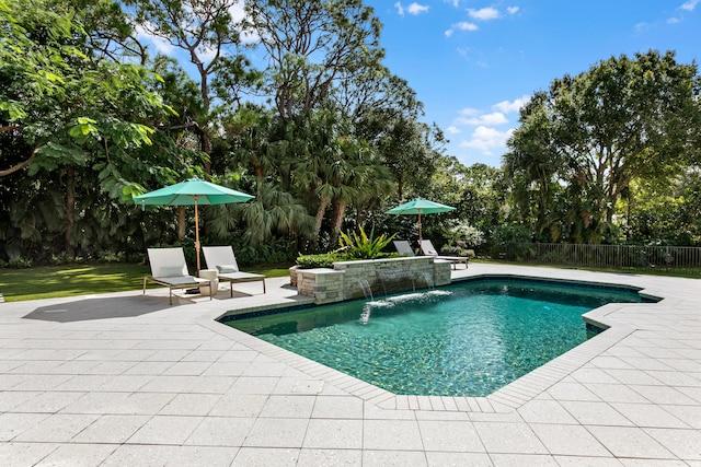 view of pool with a patio and pool water feature