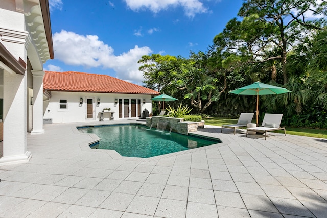 view of swimming pool featuring pool water feature and a patio area