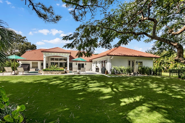 back of house with a yard and a patio area