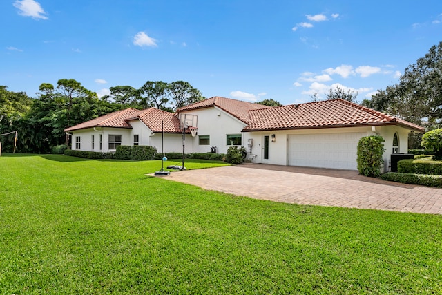 mediterranean / spanish-style home with a front yard and a garage