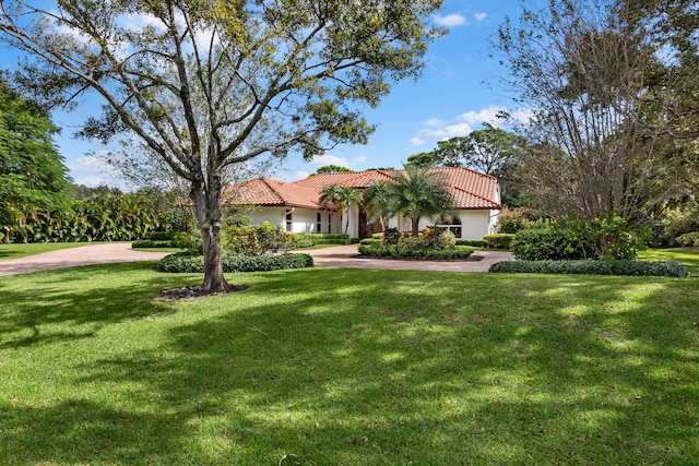 mediterranean / spanish home featuring a front yard