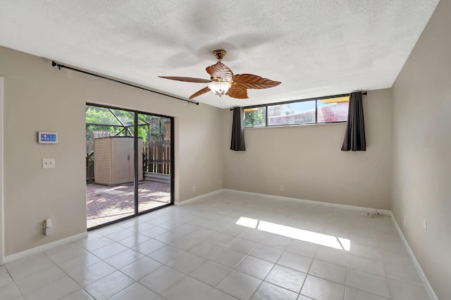 unfurnished room featuring light tile patterned flooring, a textured ceiling, a healthy amount of sunlight, and ceiling fan