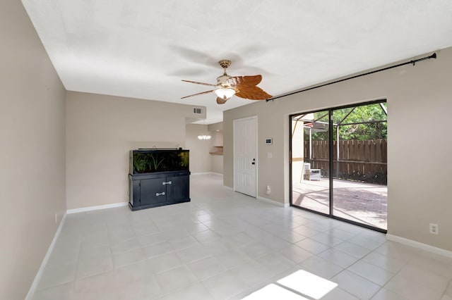 unfurnished living room featuring light tile patterned floors and ceiling fan