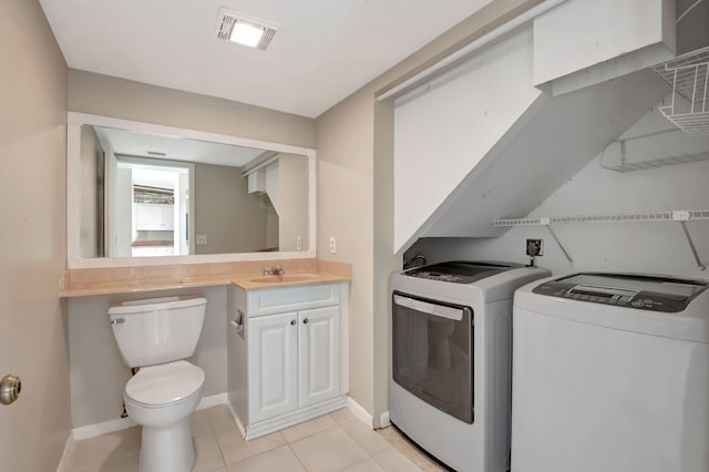 laundry area featuring sink, washing machine and clothes dryer, and light tile patterned floors