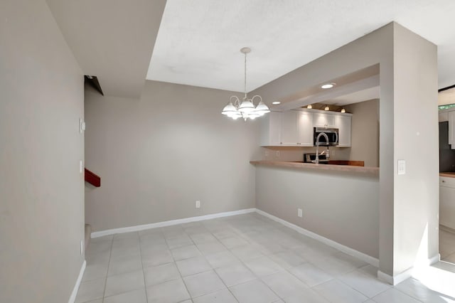 unfurnished dining area with a notable chandelier and light tile patterned floors