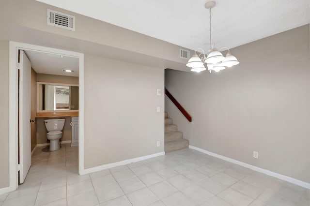 unfurnished room featuring a notable chandelier and light tile patterned floors