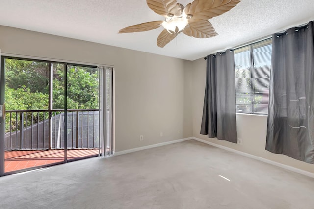 empty room with ceiling fan, carpet flooring, and a textured ceiling