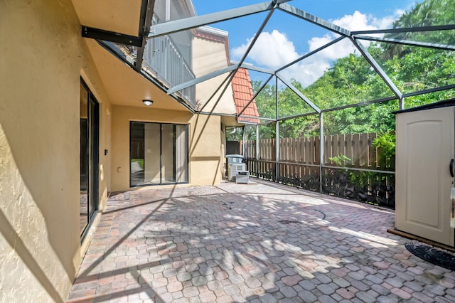 view of patio / terrace featuring glass enclosure