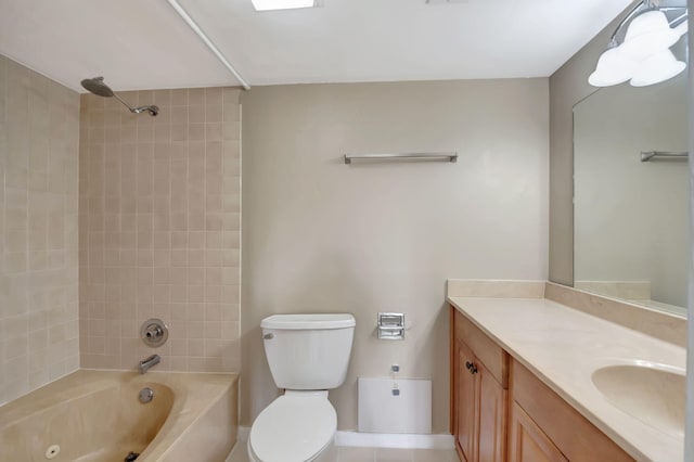 full bathroom featuring vanity, tiled shower / bath combo, and toilet