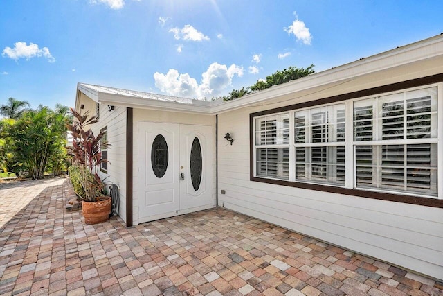 property entrance featuring a patio