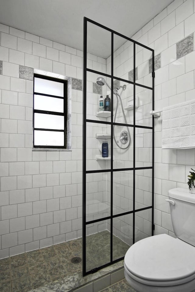 full bath with a shower stall and toilet