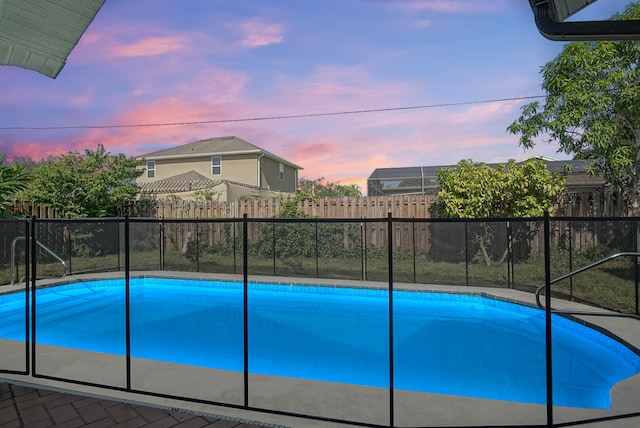 view of pool at dusk