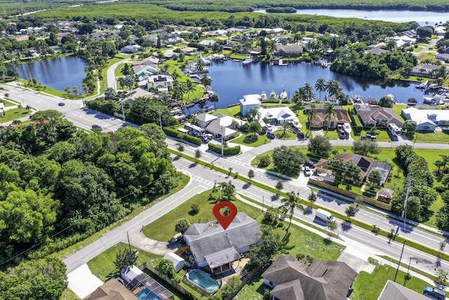 birds eye view of property with a water view and a residential view