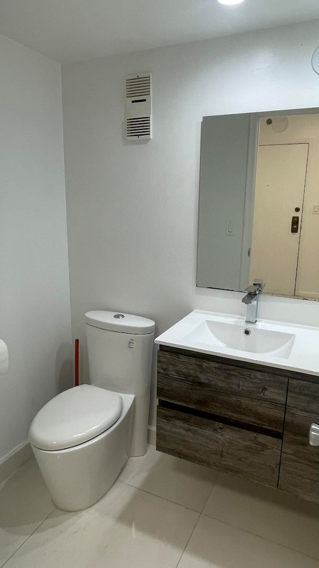 bathroom with vanity, toilet, and tile patterned flooring