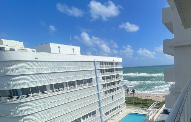 balcony featuring a water view and a beach view