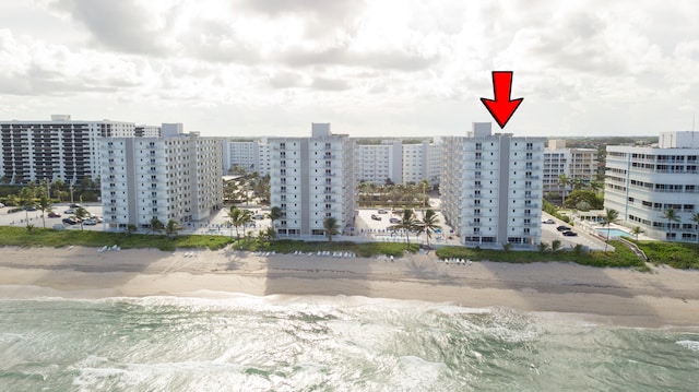 aerial view with a water view and a beach view