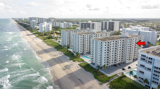 bird's eye view with a water view and a beach view