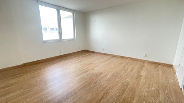 spare room featuring light hardwood / wood-style flooring