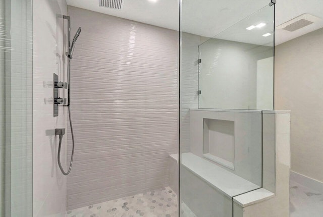 bathroom with a tile shower