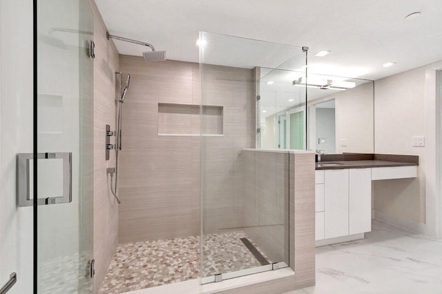 bathroom with vanity and a shower with shower door