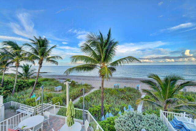 view of swimming pool with a patio area and a water view