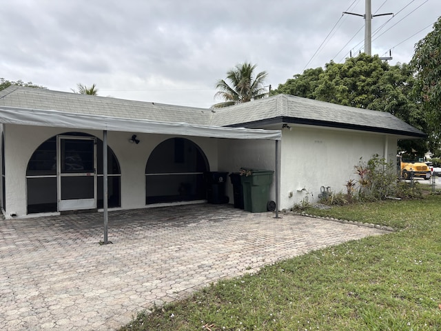 rear view of house featuring a lawn