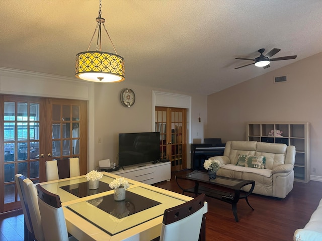 dining room with a textured ceiling, dark hardwood / wood-style floors, ceiling fan, and lofted ceiling