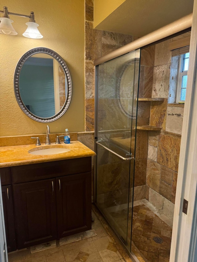 bathroom featuring vanity and a shower with shower door