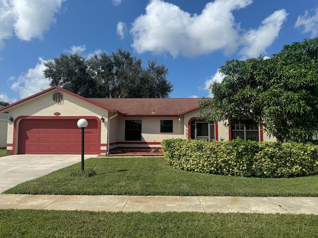 ranch-style home with a garage and a front lawn