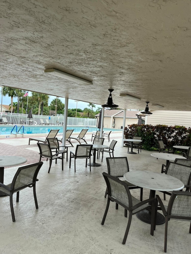 view of patio / terrace featuring ceiling fan and a community pool