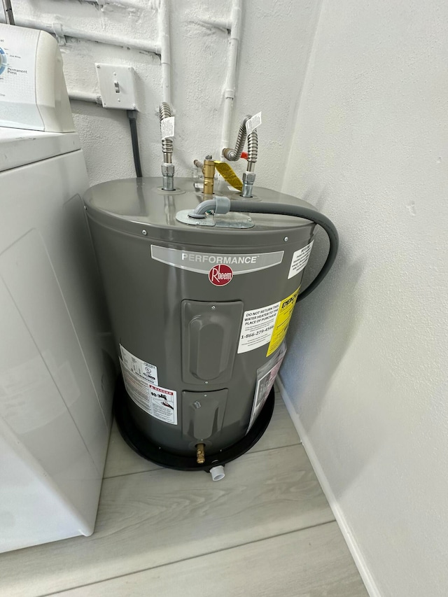 utility room featuring washer / dryer and electric water heater