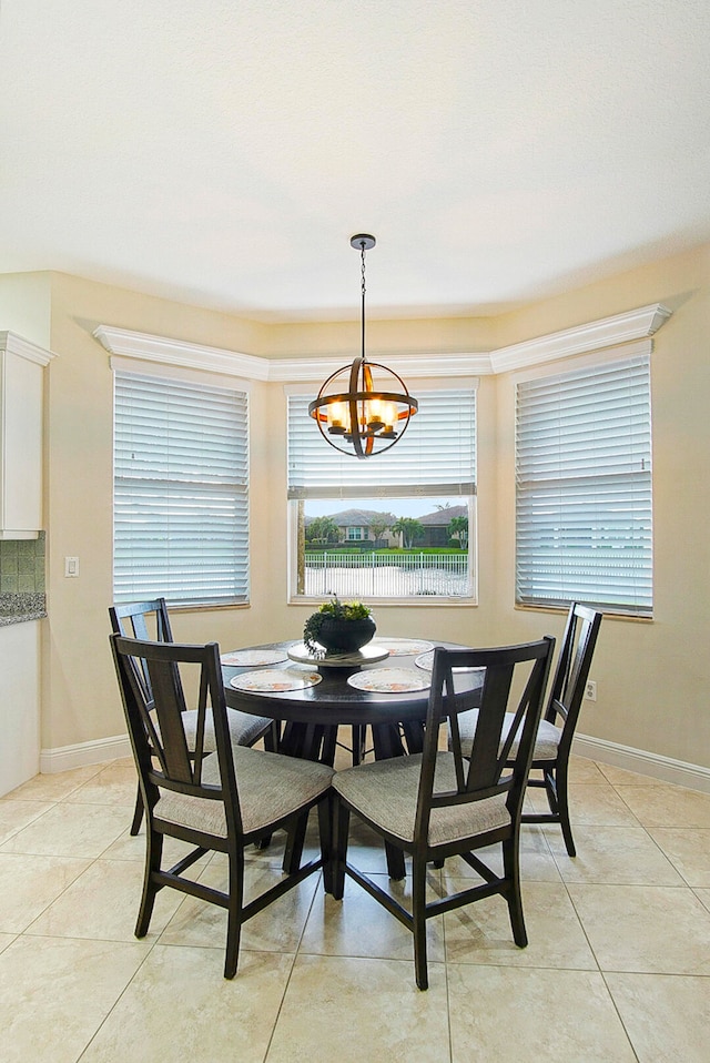 tiled dining area with a chandelier