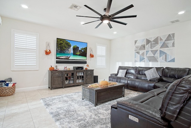 tiled living room with ceiling fan