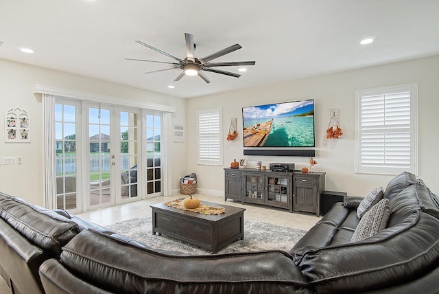 tiled living room featuring french doors and ceiling fan