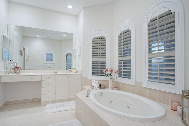 bathroom with vanity, tiled tub, and tile patterned floors