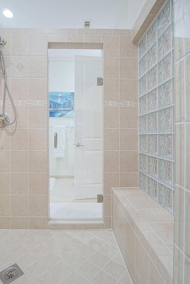 bathroom with tile patterned floors and an enclosed shower