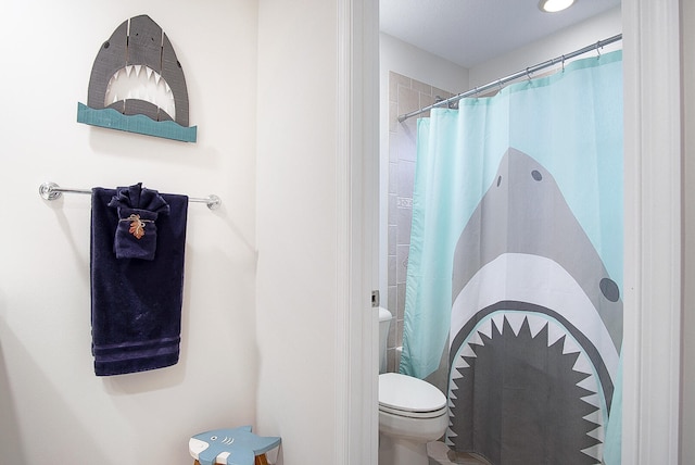 bathroom with toilet and curtained shower