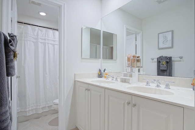 bathroom featuring vanity, curtained shower, toilet, and tile patterned floors