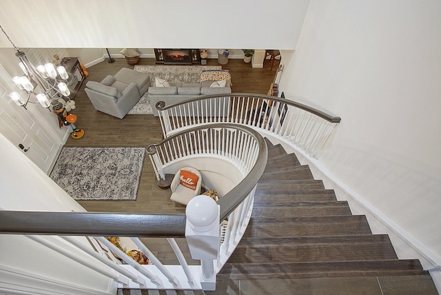 stairs featuring an inviting chandelier and hardwood / wood-style floors