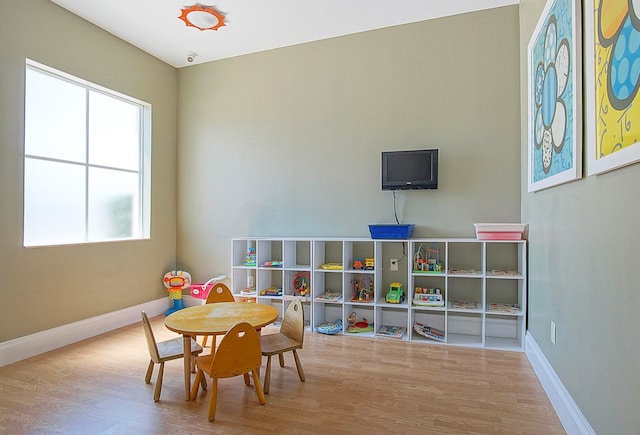 game room with light hardwood / wood-style floors