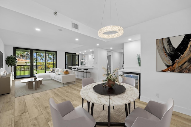 dining area with light wood finished floors, baseboards, visible vents, and recessed lighting