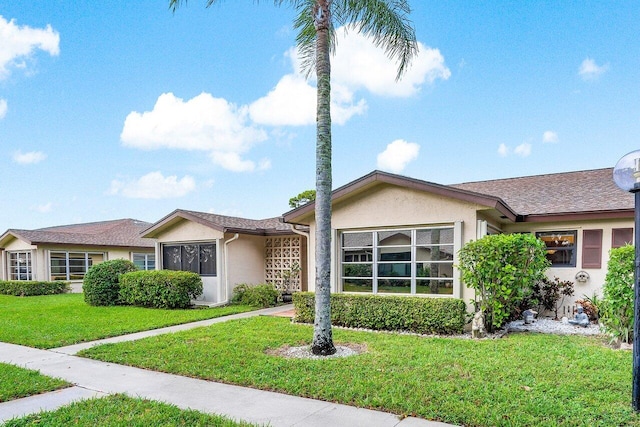 single story home featuring a front yard