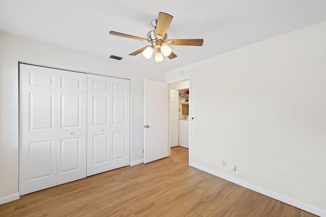 unfurnished bedroom featuring a closet, light hardwood / wood-style floors, and ceiling fan