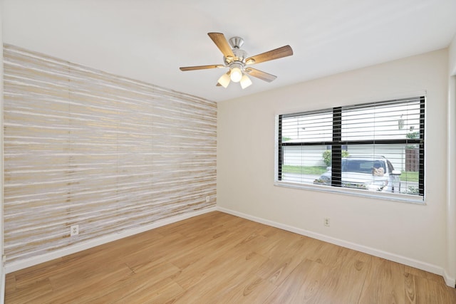 spare room featuring ceiling fan and light wood-type flooring