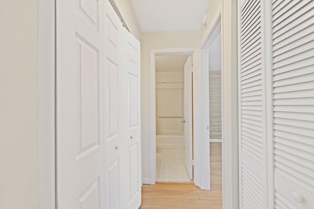 corridor with light wood-type flooring