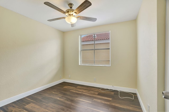 spare room featuring dark hardwood / wood-style flooring and ceiling fan