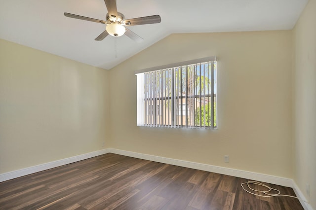 spare room with dark hardwood / wood-style floors, ceiling fan, and lofted ceiling