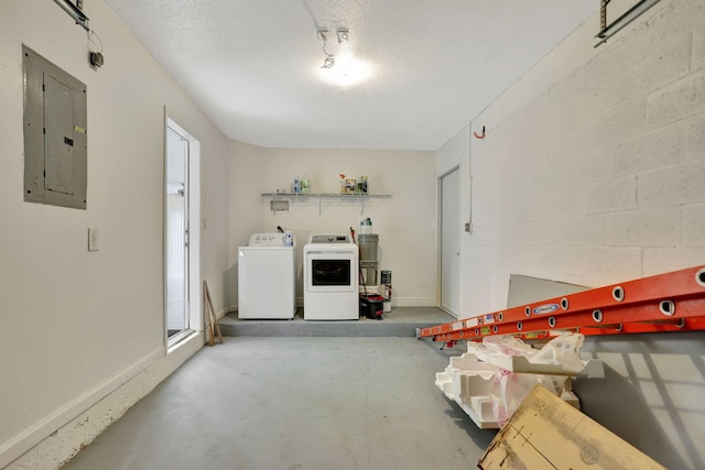 garage with washing machine and dryer and electric panel