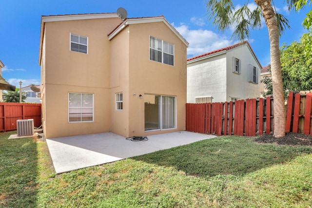 rear view of property with a yard, a patio area, and central air condition unit