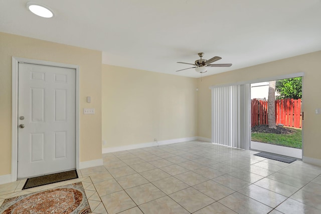 tiled empty room featuring ceiling fan